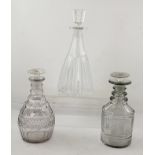 TWO EARLY 19TH CENTURY CUT GLASS DECANTERS, with mushroom stoppers, together with a larger fluted