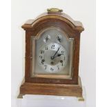 A 1920's OAK CASED JUNGHANS BRACKET CLOCK having arched case with handle, eight day mechanism with