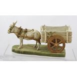 A ROYAL DUX MODEL OF A DONKEY AND CART BONBON DISH/POSY HOLDER with details and gilt highlights on a
