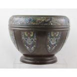 AN EARLY 20TH CENTURY CHINESE BRONZE VESSEL of circular tapered form decorated with inset panels