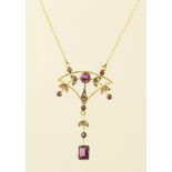 AN ART NOUVEAU SEED PEARL AND AMETHYST GOLD COLOURED METAL SET PENDANT of fan shaped form with