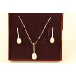 A SUITE OF RHODIUM FINISHED WHITE GOLD COLOURED METAL JEWELLERY, comprising a pendant, a pair of