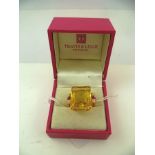 A 30ct. CITRINE AND RUBY ART DECO RING, on a silver gilt shank, size Q