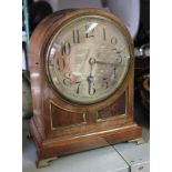 AN EDWARDIAN MAHOGANY CASED MANTEL CLOCK having silvered dial with Arabic numerals, raised on