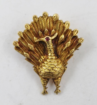 A RUSSIAN GOLD COLOURED METAL BROOCH, fashioned as a peacock with single red stone eye and tooled - Image 2 of 3