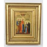 A RUSSIAN ICON, painted and richly gilded on panel, depicts the Madonna with attendants blessing a