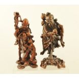 TWO 20TH CENTURY ORIENTAL CARVED AND POLISHED ROOTWOOD CARVINGS OF IMMORTALS, both with Lotus