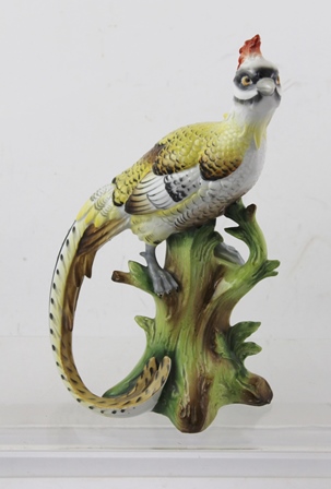 A LATE 19TH CENTURY PORCELAIN MODEL OF THE "CHELSEA BIRD", perched on a tree stump, decorated in