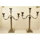 A PAIR OF SILVER PLATED CANDELABRAS, each having Corinthian column design with twin branches