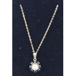 A GOLD COLOURED METAL SET PEARL AND SAPPHIRE PENDANT, having single central pearl with eight