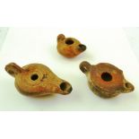 THREE ROMAN TERRACOTTA OIL LAMPS, circa 400 A.D., largest 10cm