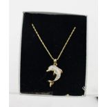 A GOLD COLOURED METAL AND DIAMOND SET "FLIPPER" DOLPHIN SHAPED PENDANT, set with 8/8 cuts, on chain