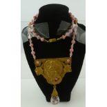 A CZECHOSLOVAKIAN ART NOUVEAU NECKLACE with pink pinch beads knotted and cast gilt metal pendant