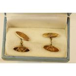 A PAIR OF EARLY 20TH CENTURY 9CT GOLD CHAIN CUFFLINKS, each with two bright cut navette shape pads