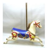 A FAIRGROUND GALLOPING CAROUSEL HORSE the fibreglass body elaborately painted, with spiral brass