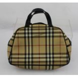 A "BURBERRY" HANDBAG, having black leather handles with classical "Burberry" tartan, base 28cm wide