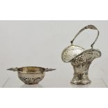 A CONTINENTAL WHITE METAL BONBON BASKET, pierced and cast with floral swags, swing handle and