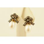 A PAIR OF VICTORIAN STYLE GOLD COLOURED METAL SET EARRINGS, each having a stud with a bow of