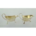 ADOLF SCOTT LTD A PAIR OF CHIPPENDALE STYLE SILVER SAUCE BOATS each having cut rim with upswept wire