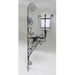A SET OF FOUR CIRCA 1880's WROUGHT IRON FANCY WALL LAMPS, with multiple scrolls and wrought twin