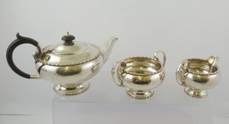WALKER AND HALL A MID 20TH CENTURY THREE PIECE SILVER TEASET with beaded rims, comprising; teapot,