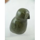 A CANADIAN INUK STONE CARVING OF AN OWL, bears a label "Canada Eskimo Art", 1982, 21cm high