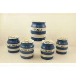 A COLLECTION OF FIVE T G GREEN CORNISH WARE BLUE AND WHITE BANDED STORAGE JARS with covers, names