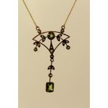 AN EDWARDIAN STYLE GOLD COLOURED METAL SET OLIVINE, DIAMOND AND SEED PEARL PENDANT, fashioned with a