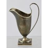 SPURRIER & CO. A GEORGIAN STYLE SILVER CREAM JUG, having rolled rim, swept handle, plain tapered