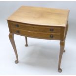 AN EARLY TO MID 20TH CENTURY OAK CANTEEN CABINET, bow fronted, of two drawers with brass ring