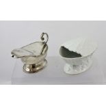 A VICTORIAN SILVER PLATED HINGED LIDDED SPOON WARMER of gravy boat design with C-scroll acanthus