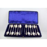 WILLIAM HUTTON & SONS A SET OF TWELVE SILVER "RAT TAIL" PATTERN TEASPOONS AND PAIR OF TONGS, each