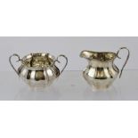 A SILVER SUGAR AND MILK (morning size), each having beaded rim and baluster panelled belly,