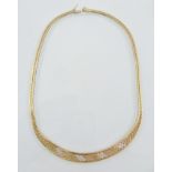 A 9CT MIXED GOLD NECKLACE the herringbone ends opening to a brickwork link broader middle