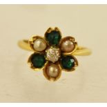 AN EMERALD DIAMOND AND SEED PEARL DRESS RING having three emeralds, three seeds and a central