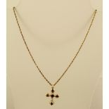 A FANCY 9CT GOLD CROSS set in a heart and four pear shaped garnets on Prince of Wales gold