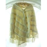 A VICTORIAN CREAM SILK CAPE with all over tiered fringes and pleated silk detail and borders