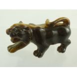 A SMALL 20TH CENTURY SCULPTURE OF A PROWLING TIGER, carved from 'Tiger's Eye' quartz, 8cm long x 4cm