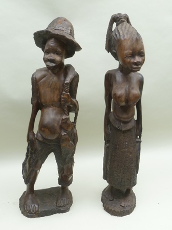 A PAIR OF 20TH CENTURY AFRICAN CARVED HARDWOOD FETISH OR FERTILITY FIGURES, in the form of a man and