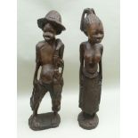 A PAIR OF 20TH CENTURY AFRICAN CARVED HARDWOOD FETISH OR FERTILITY FIGURES, in the form of a man and
