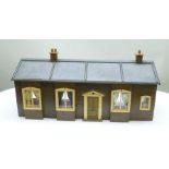 AN EARLY 20TH CENTURY DOLL'S HOUSE "STATION HOUSE" single storey, painted wood construction, front