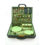 A 1930's GREEN LEATHER TRAVELLING DRESSING CASE, having an almost full complement of electro