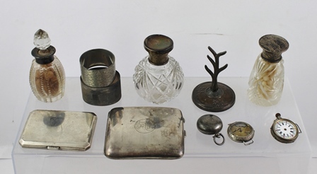 A MIXED LOT OF SILVER, comprising two cigarette cases, two watches, three bottles, a ring tree and a