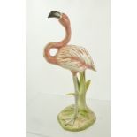 A GOEBEL 1979 PORCELAIN MODEL OF A FLAMINGO standing in reeds, decorated in matt polychrome, 20cm