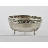 ALBERT EDWARD JONES A SILVER BOWL, having repousse worked foliate rim, spot hammered bowl, raised on