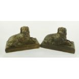A PAIR OF CAST AND PAINTED MANTEL ORNAMENTS fashioned as recumbent dogs, 12cm x 17cm