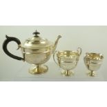 SIR JOHN BENNETT LTD A GEORGIAN DESIGN THREE PIECE SILVER TEASET of pedestal and raised circular