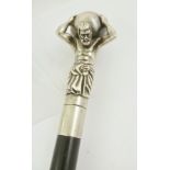 A PROBABLY LATE 19TH/EARLY 20TH CENTURY SILVER COLOURED METAL WALKING CANE, the knop cast as Atlas