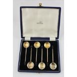 WALKER & HALL A SET OF SIX SILVER GILT AND ENAMELLED BEAN TERMINAL SPOONS, the back of each