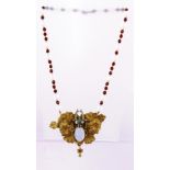 AN ART NOUVEAU INFLUENCED RED AND WHITE BEAD AND DIAMANTE SET PENDANT NECKLACE, fashioned with a